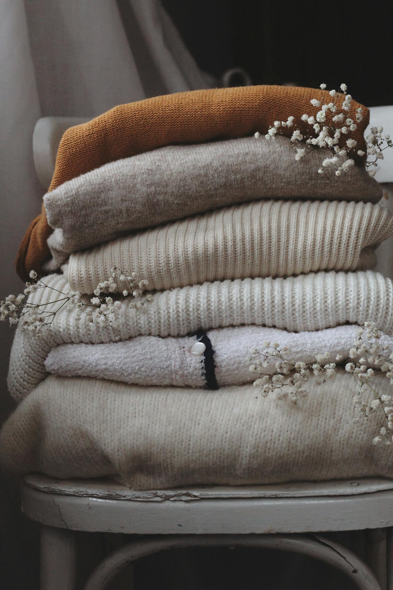 A stack of neatly folded cozy sweaters